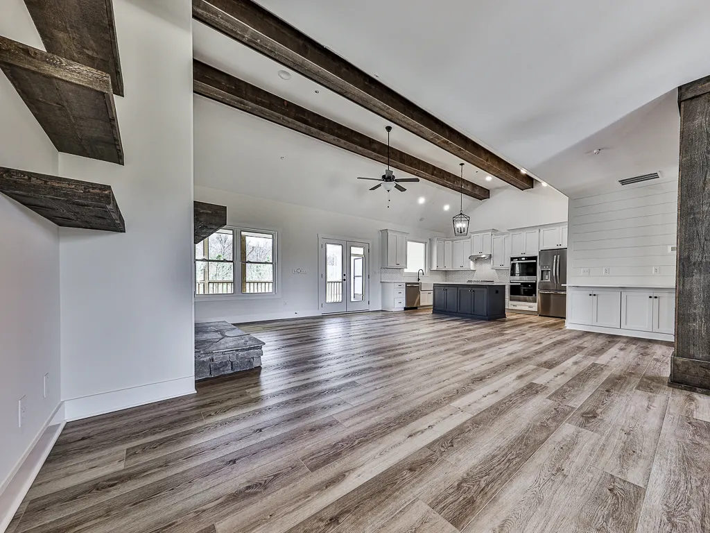 The Modern Craftsman &mdash; vaulted great room with exposed beams in Ball Ground, GA