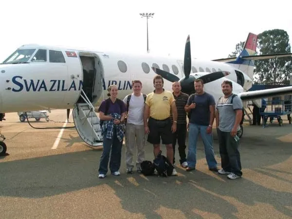 The 2004 mission team beside a Swaziland Airlink plane